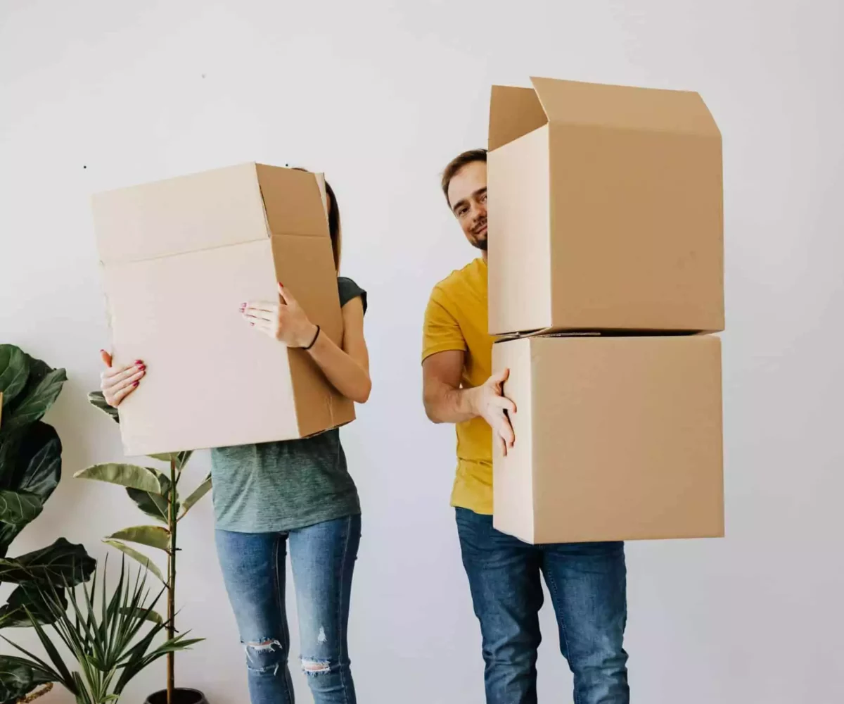 Mini Mall Storage renters holding boxes and sharing a storage unit