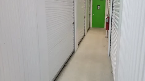 Clean well lit hallway of indoor self storage facility