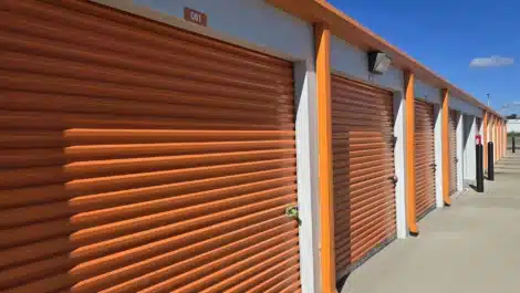 close up of orange roll up doors on self storage unit