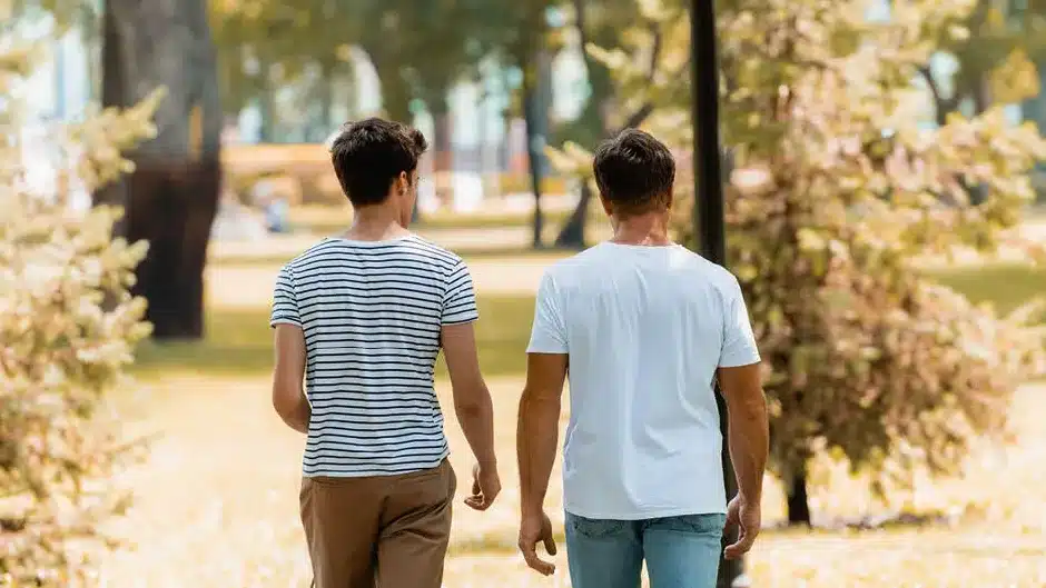 Two people walking through a park 