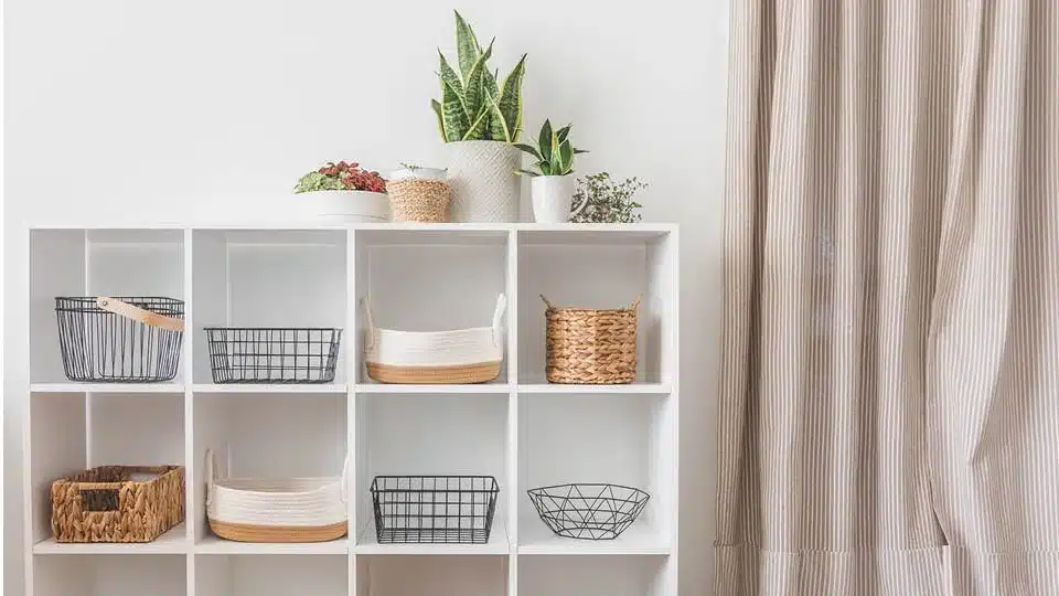 A storage self with baskets to show how you can organize your home with storage solutions
