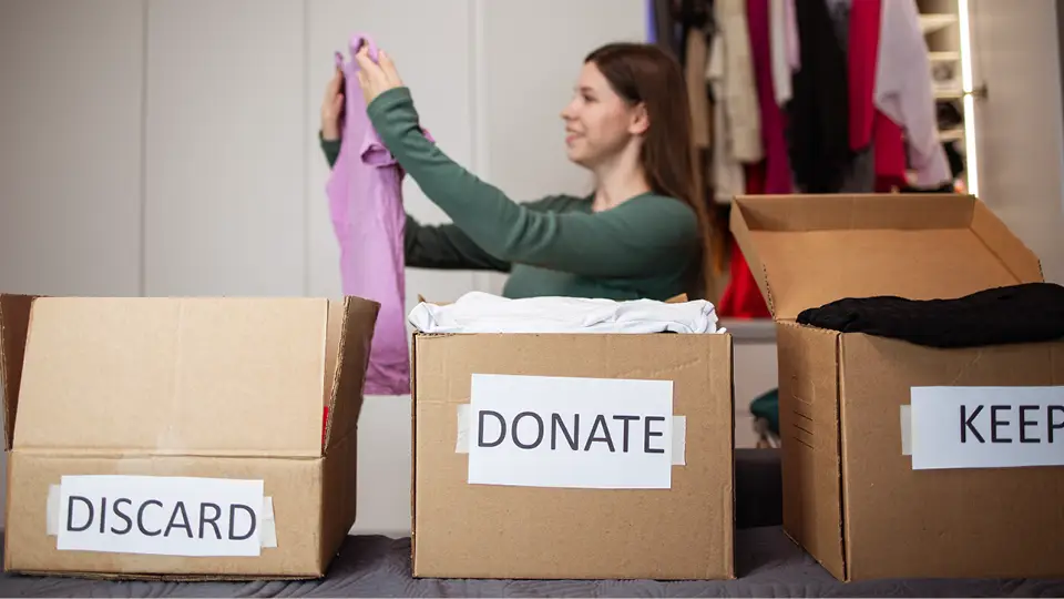 A woman sorting through clothes 