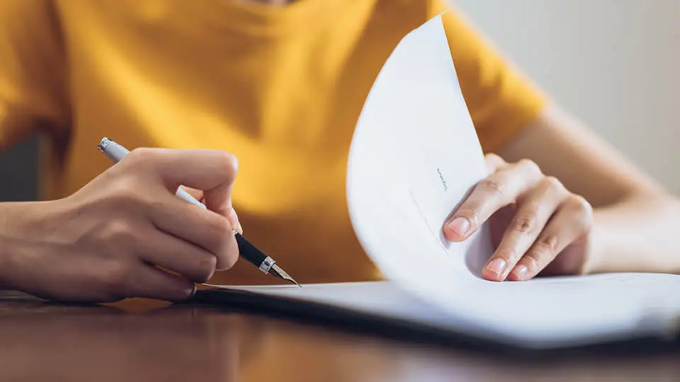 A person signing insurance 