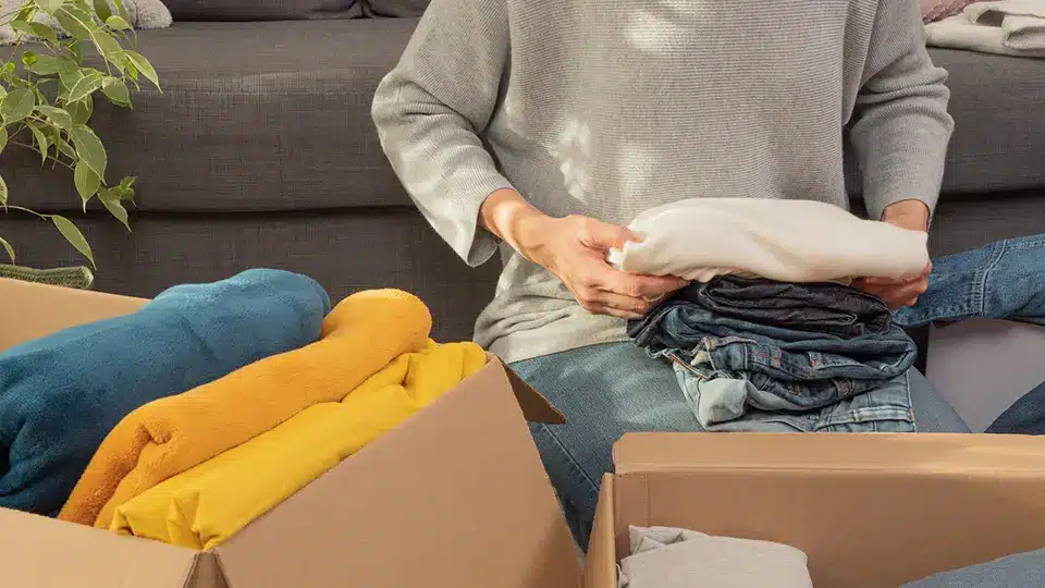 A woman packing away clothes