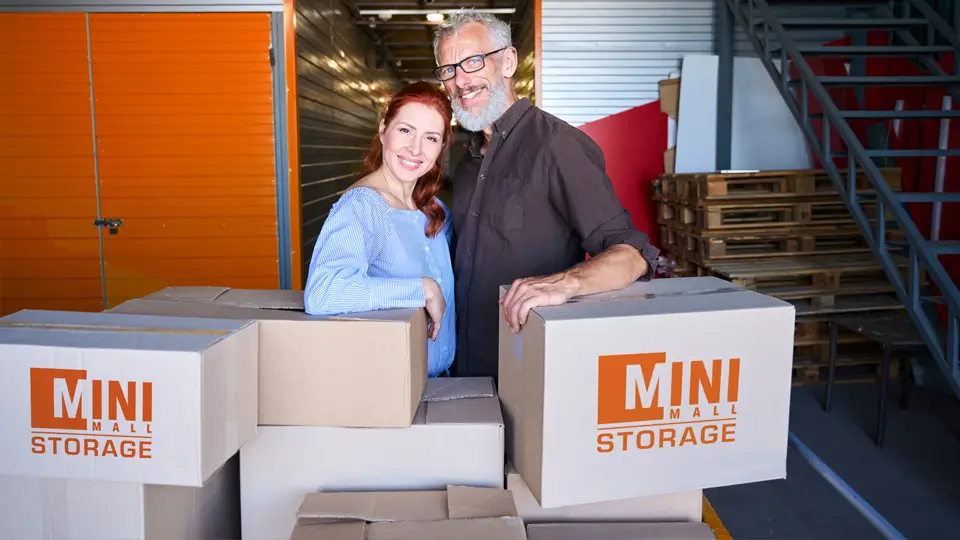 A couple moving their belongings into Mini Mall Storage